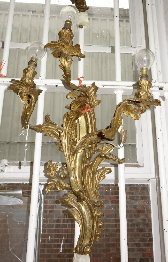 Appraisal: A pair of gilt metal rococo style three branch wall