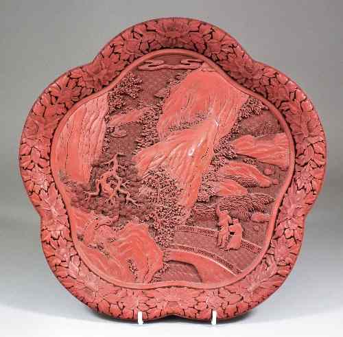 Appraisal: A Chinese red cinnabar lacquer dish of lobed outline carved