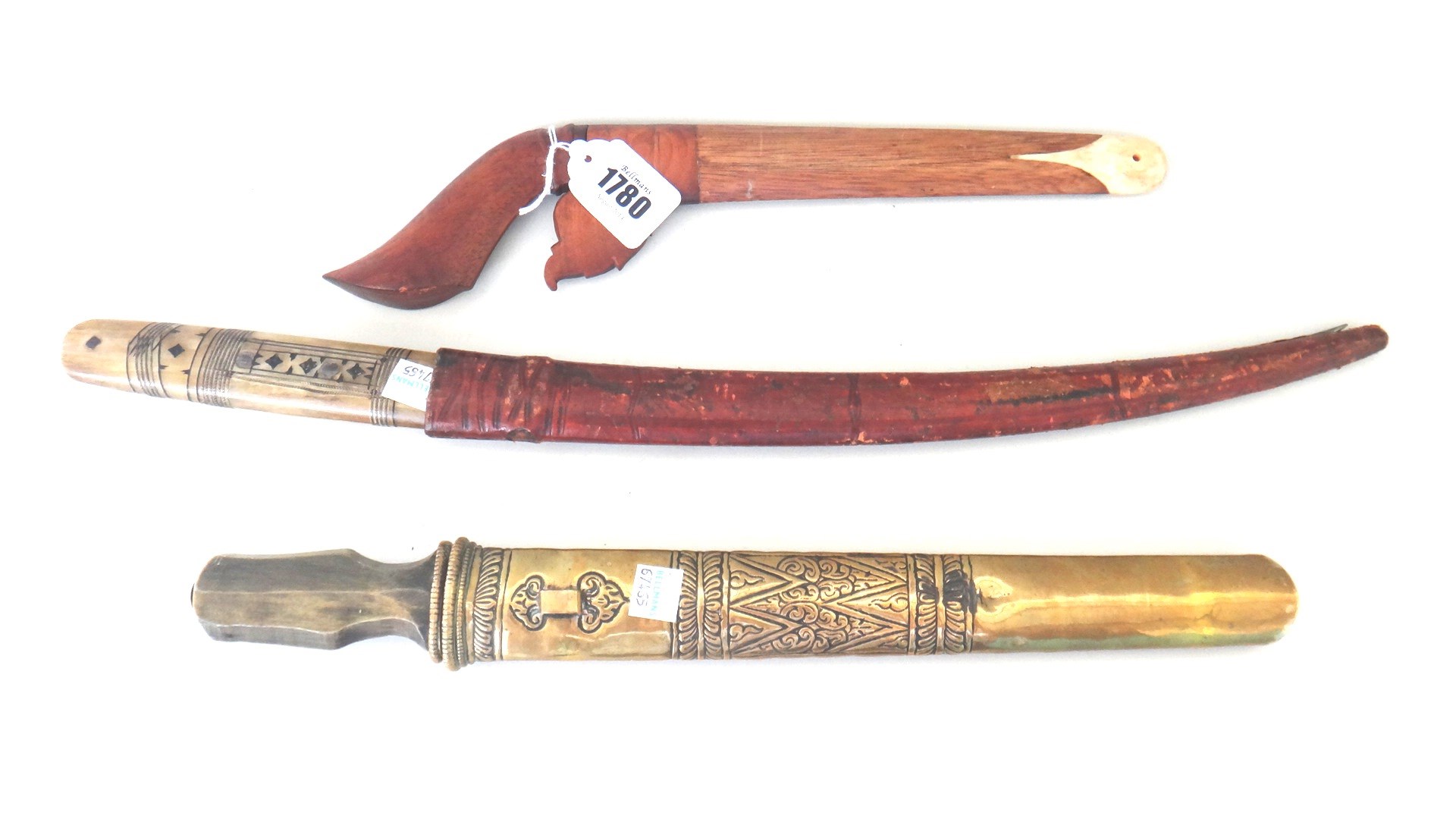 Appraisal: A small Malaysian Kris with plain wooden shaped handle and