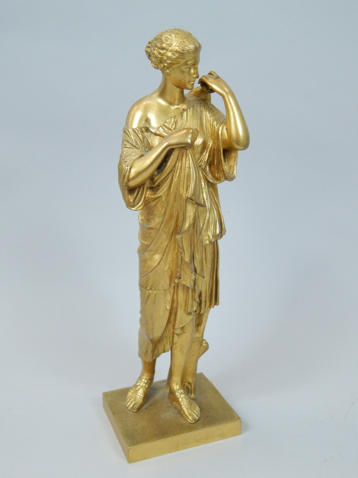 Appraisal: A thC Continental gilt bronze figure of a Neo-classical maiden