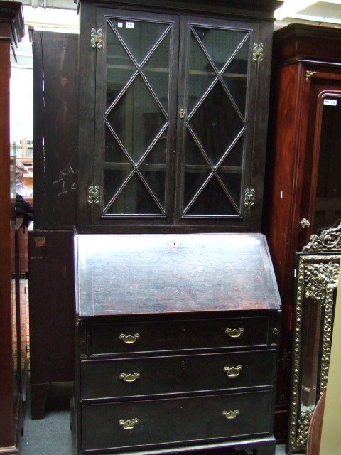 Appraisal: A th century oak bureau bookcase the stepped cornice over