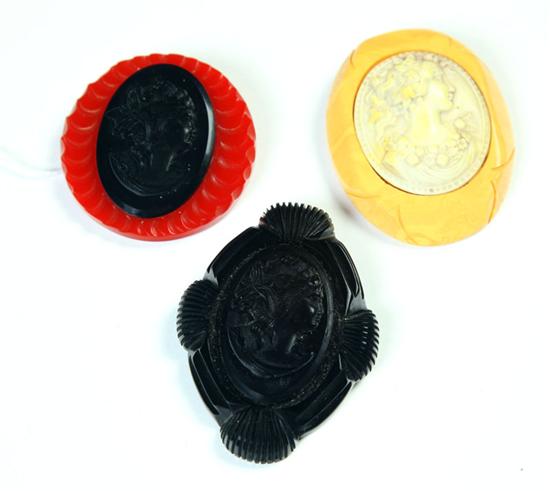 Appraisal: THREE BAKELITE CAMEO PINS American Ca - Yellow and off-white