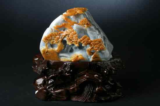 Appraisal: CHINESE CELADON AND RUSSET JADEITE PEBBLE Carved with pagoda and