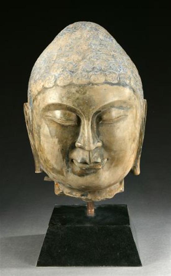 Appraisal: A CHINESE GREY STONE HEAD OF BUDDHA His face with