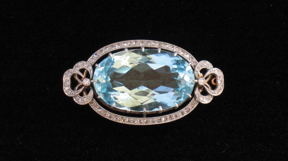 Appraisal: A LARGE AQUAMARINE AND DIAMOND BROOCH the oval cushion-cut aquamarine