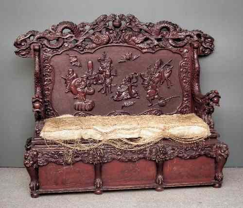 Appraisal: An impressive Chinese stained wood hall bench boldly carved throughout