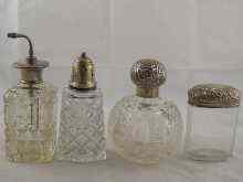 Appraisal: Four cut glass dressing table bottles with silver mounts