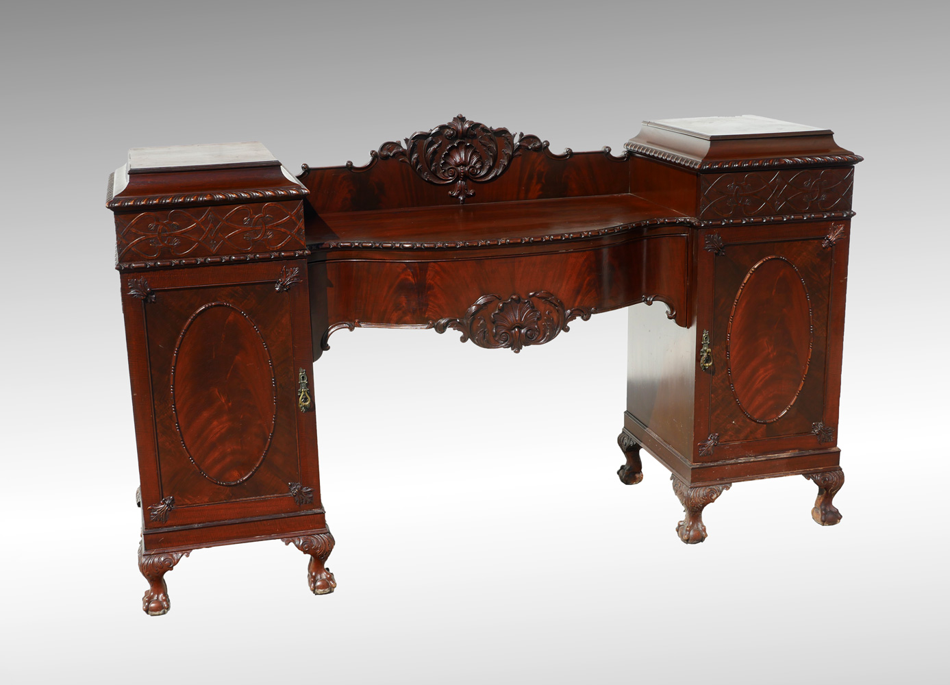 Appraisal: CHIPPENDALE CARVED SIDEBOARD Carved shell foliate crest flanked by hidden