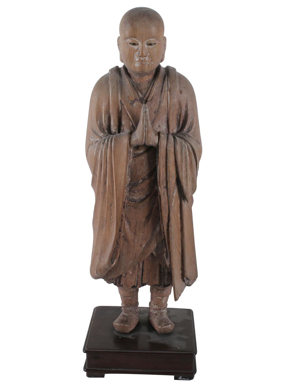 Appraisal: ASIAN FIGURE OF BUDDHAcarved wood figure resting on an ebony