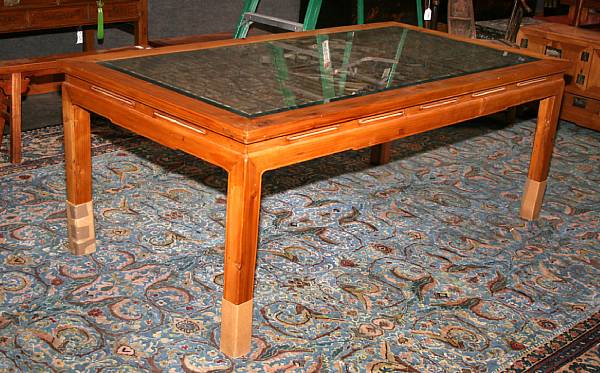 Appraisal: A Chinese softwood rectangular table The glazed top fitted with