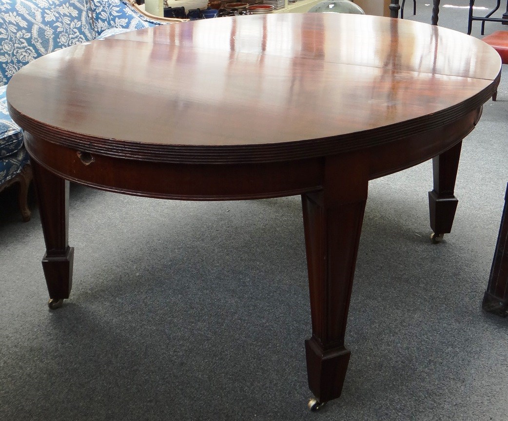 Appraisal: A th century mahogany oval extending dining table on tapering