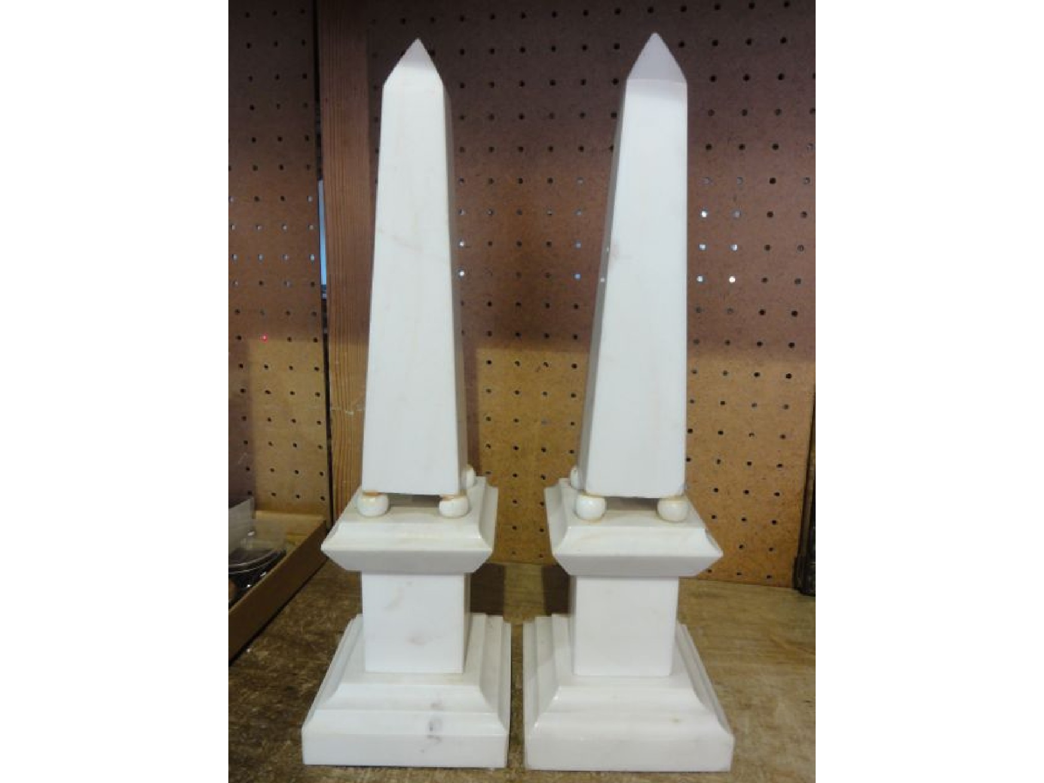 Appraisal: A pair of white marble obelisks mounted on stepped square