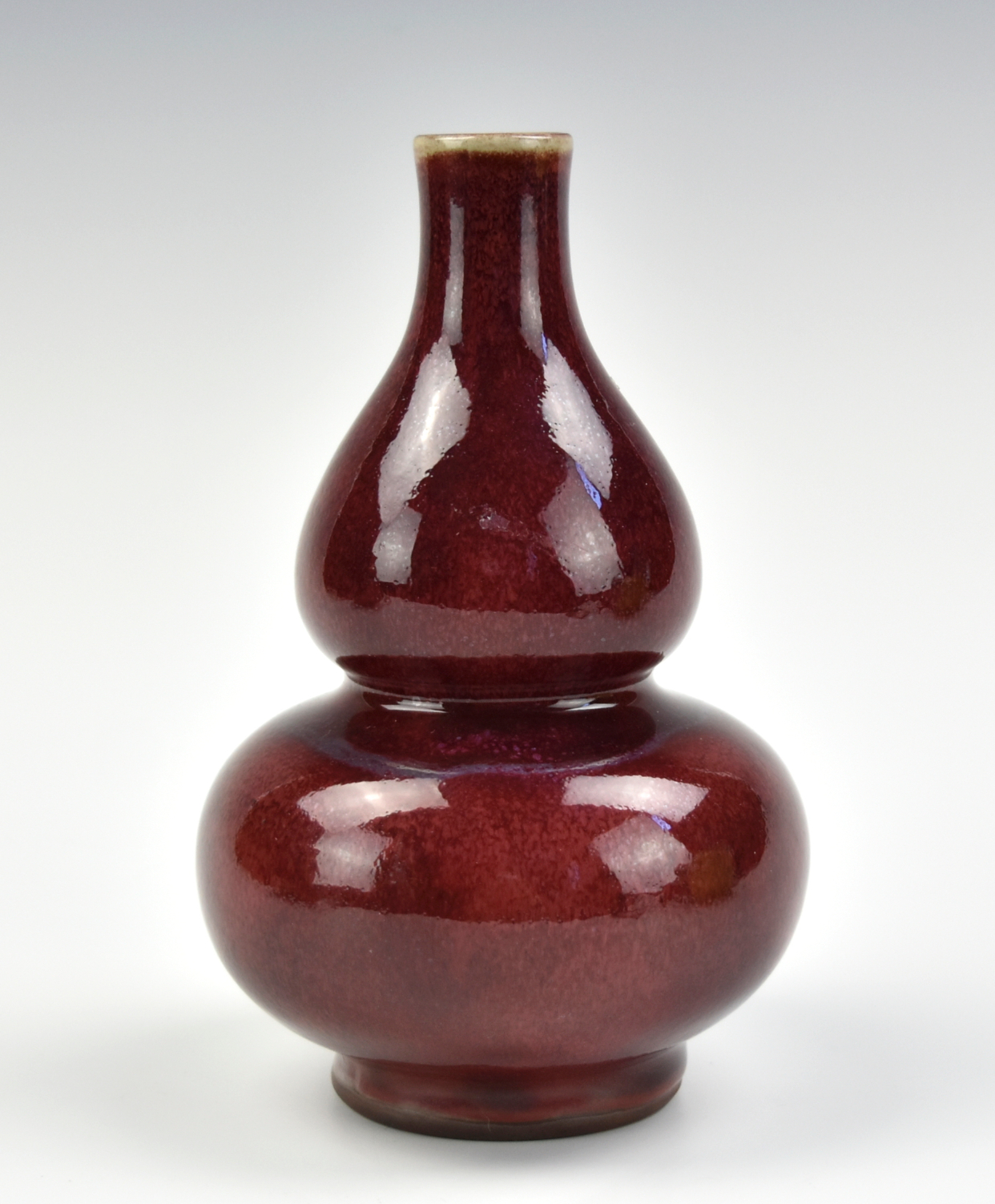 Appraisal: A Chinese red glazed double-gourd vase with bulbous lower body