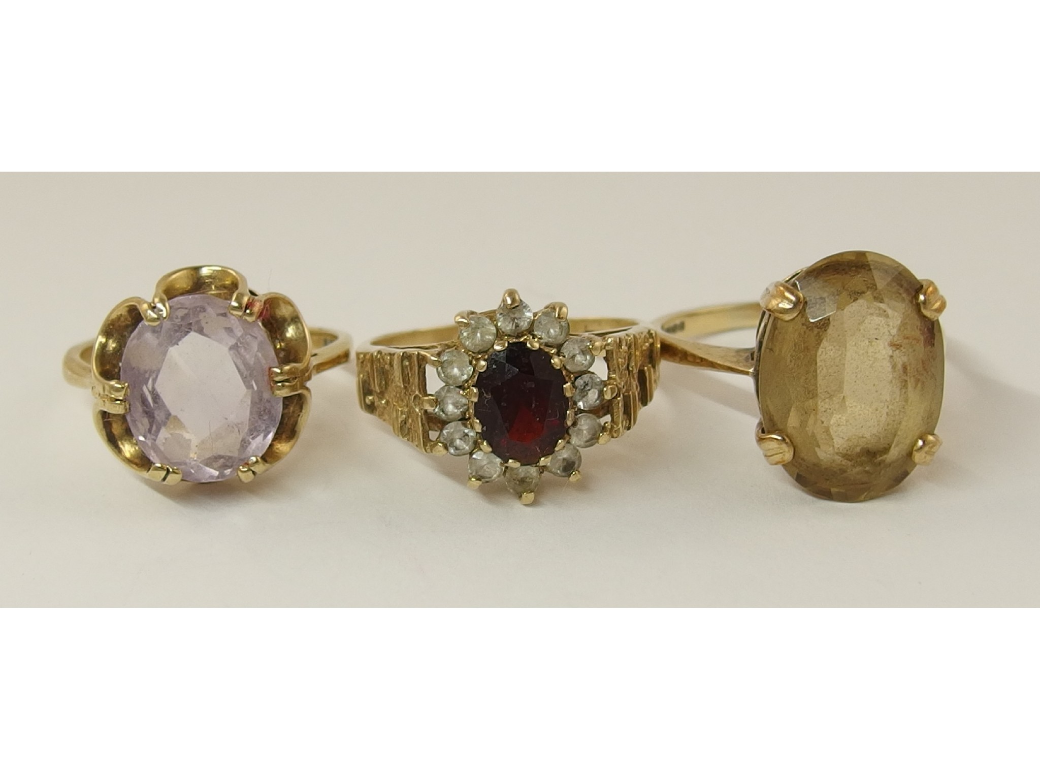 Appraisal: Three ct retro rings to include amethyst garnet and citrine