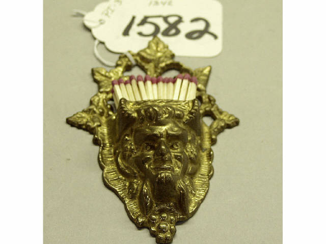 Appraisal: Devil's head wall match holder in brass Estimate -