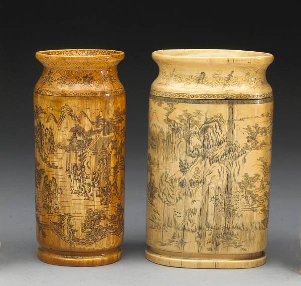 Appraisal: Two incised ivory brush pots The first of irregular flattened