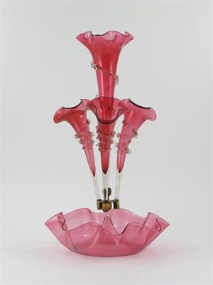 Appraisal: A cranberry glass pergne with three smaller flared trumpets around