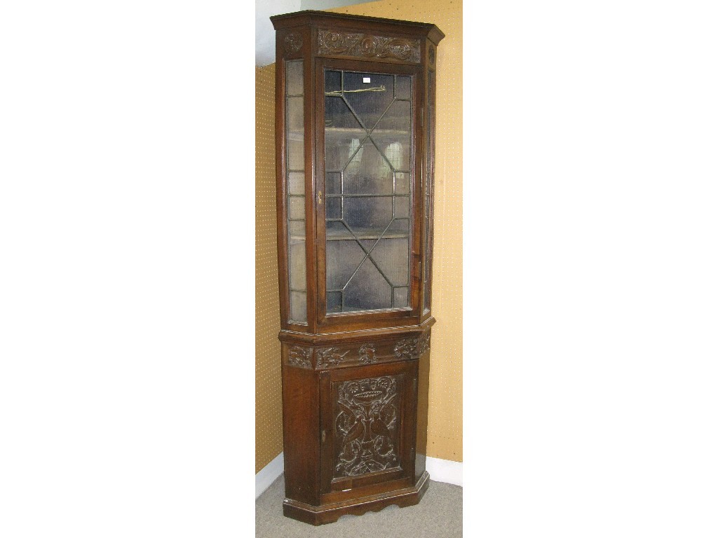 Appraisal: Leaded glass carved oak two section corner cabinet