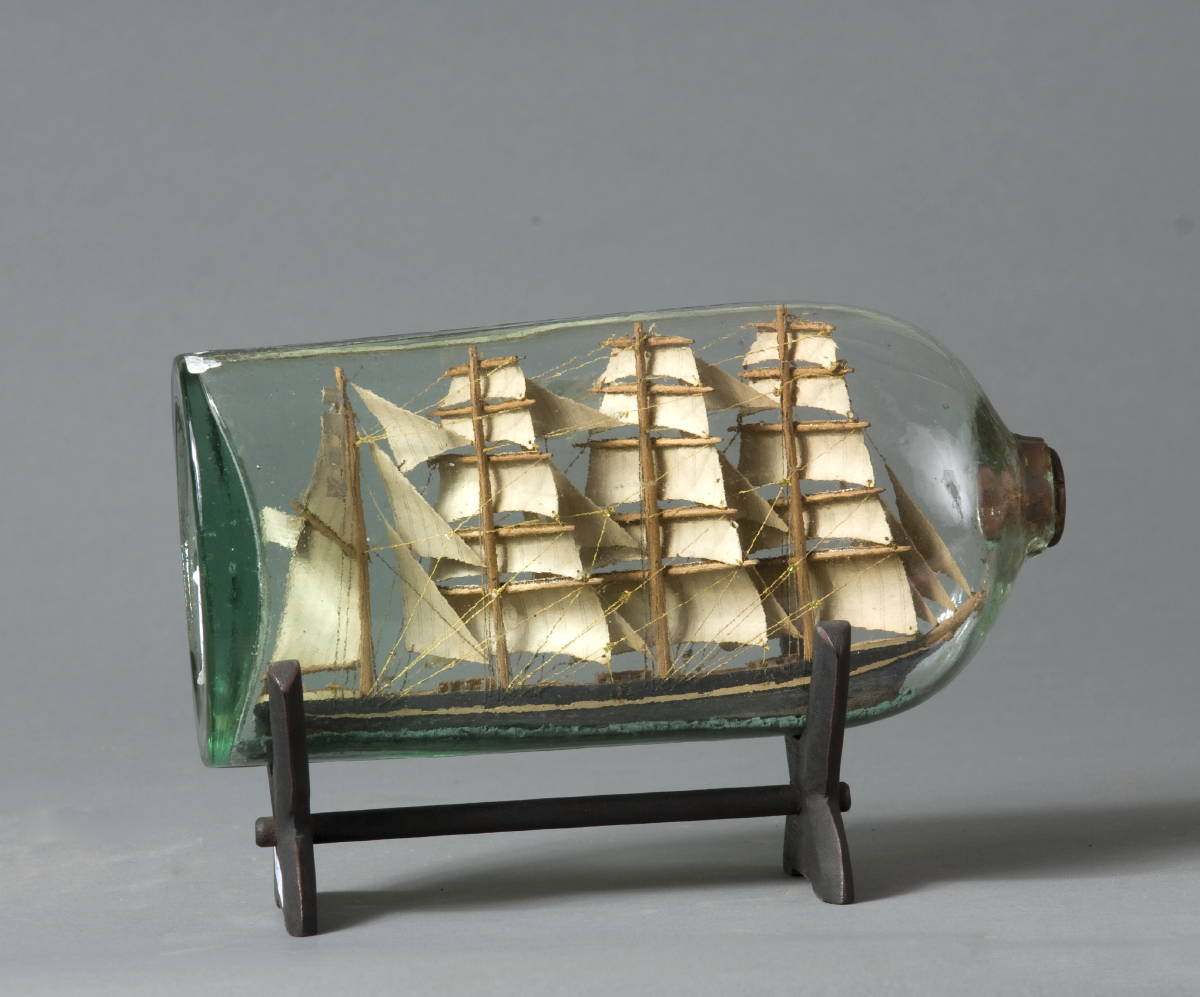 Appraisal: AMERICAN FOUR-MASTED SCHOONER SHIP-IN-A-BOTTLE Together with three nautical prints two