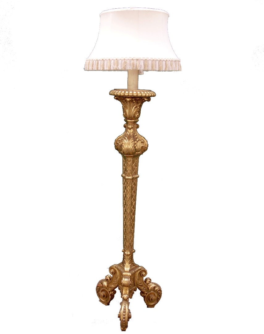 Appraisal: A carved giltwood standard lamp within blind fret decoration on