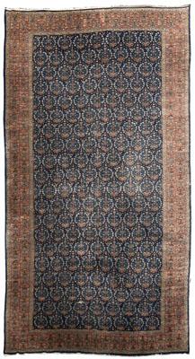 Appraisal: Oushak rug repeating floral wreaths on dark blue field amber