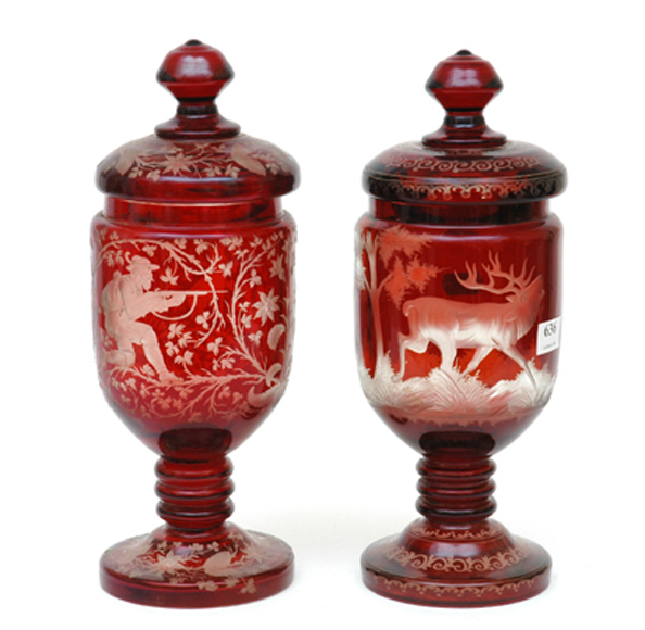 Appraisal: A MATCHED PAIR OF BOHEMIAN FLASHED RUBY GLASS LIDDED URNS