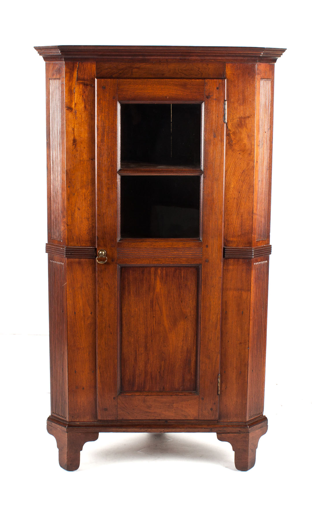 Appraisal: American vernacular walnut corner cupboard th century reeded supports single