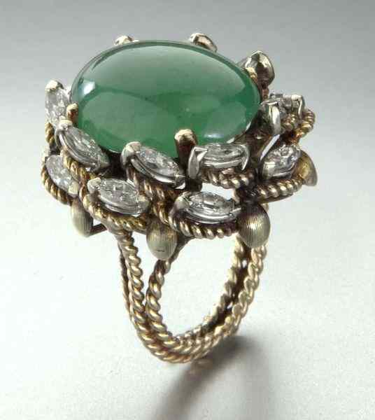 Appraisal: K gold diamond and jadeite jade ringfeaturing an oval cabochon