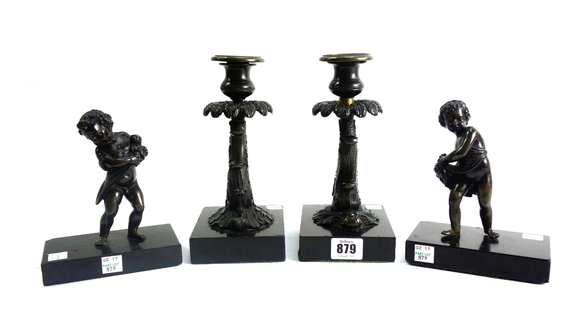 Appraisal: A pair of bronze candlesticks th century each modelled and