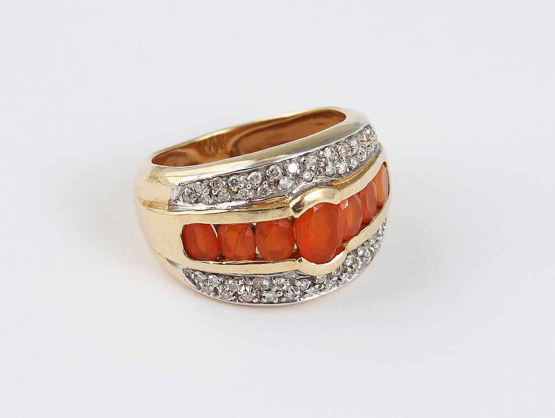 Appraisal: ORANGE MEXICAN OPAL AND DIAMOND RING K yellow gold ring