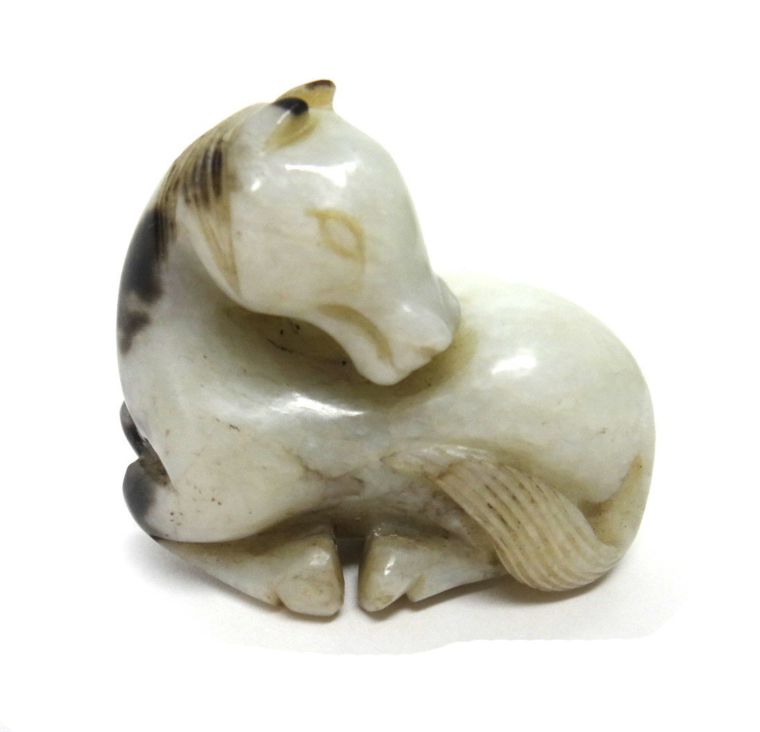 Appraisal: A creamy white and grey jade figure of a horse