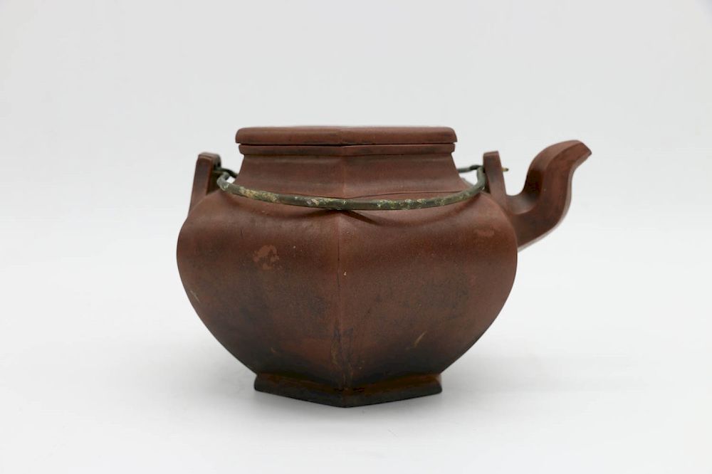 Appraisal: YIXING HEXAGONAL TEAPOT of hexagonal form with metal handles and