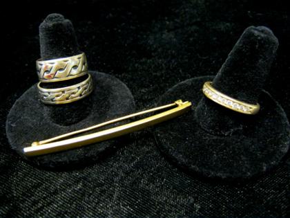 Appraisal: Three gold rings and a gold pinPin and two rings