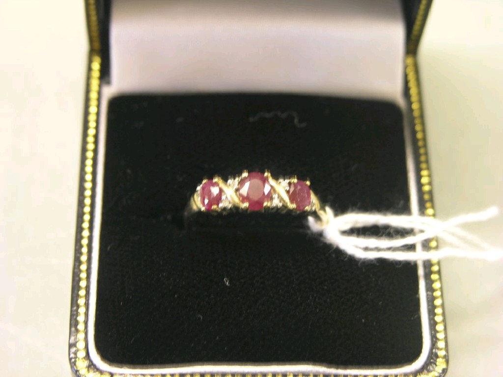 Appraisal: A ct gold ring set three red stones ring size