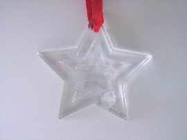 Appraisal: A crystal star shaped ornament on a red ribbon by