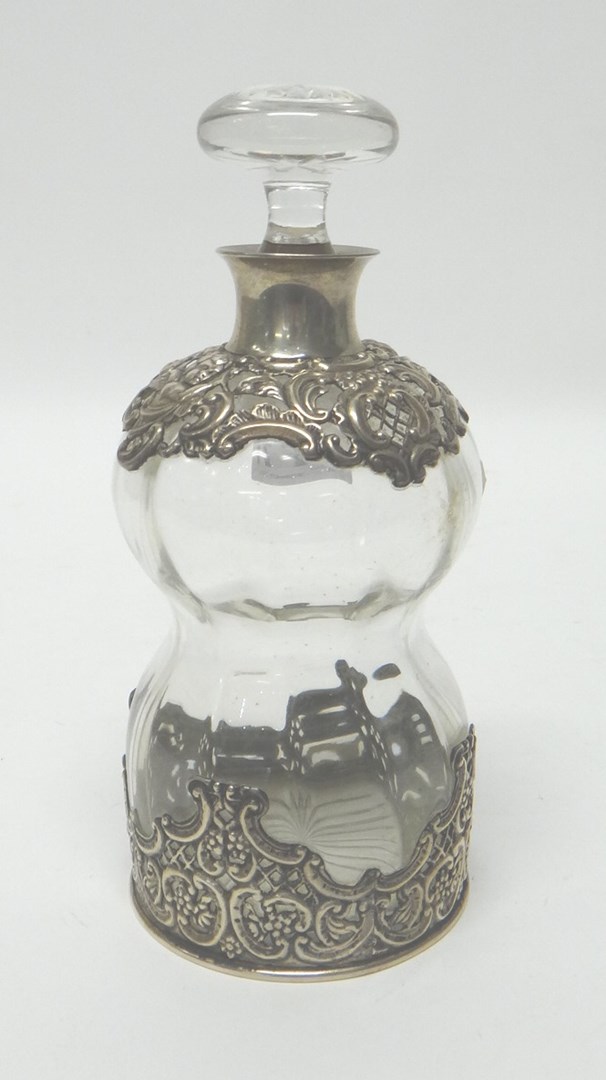 Appraisal: A silver mounted hourglass shaped decanter and stopper the mounts