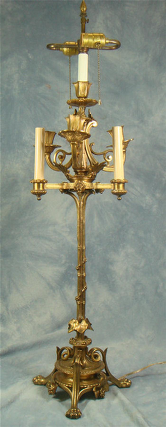 Appraisal: French gilt bronze arm candelabra converted to electric one arm