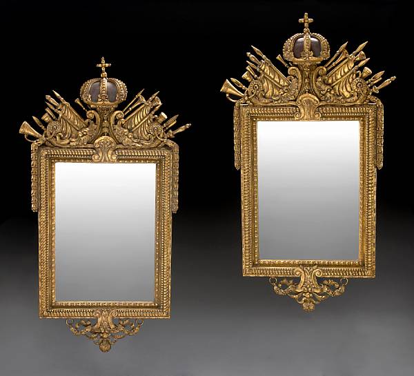 Appraisal: A pair of Continental Neoclassical style giltwood mirrors Each crest