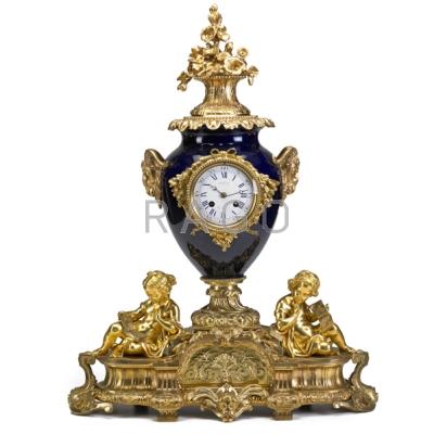 Appraisal: FRENCH DORE BRONZE MANTLE CLOCK Ram head decoration on porcelain