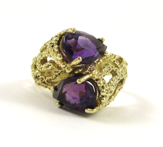 Appraisal: AMETHYST AND FOURTEEN KARAT GOLD RING set with two pear-cut