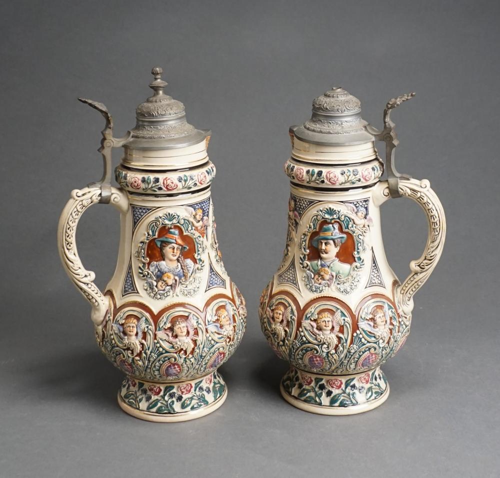 Appraisal: PAIR GERMAN PEWTER MOUNTED POLYCHROME DECORATED PITCHERS H IN CM