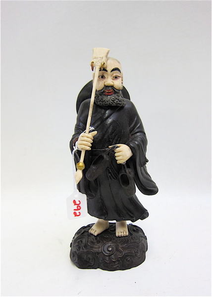 Appraisal: CHINESE HAND CARVED IVORY AND EBONIZED HARDWOOD FIGURE depicting bearded