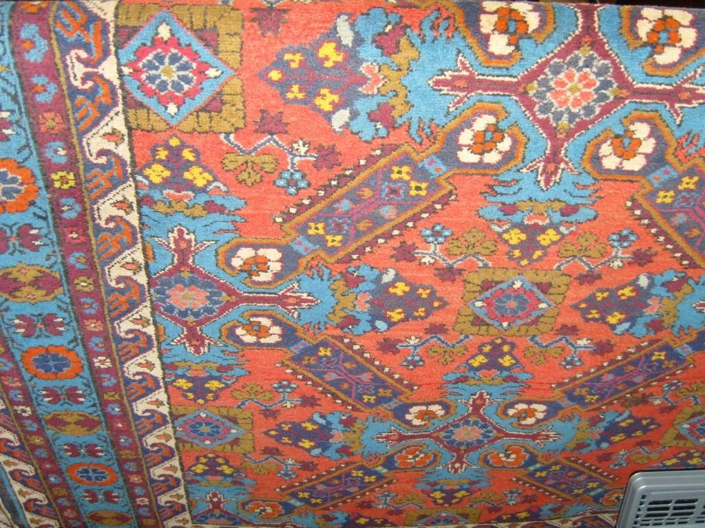 Appraisal: A red ground eastern wool rug with stylised floral decoration