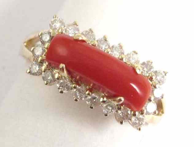 Appraisal: CORAL DIAMOND AND FOURTEEN KARAT GOLD RING set with a