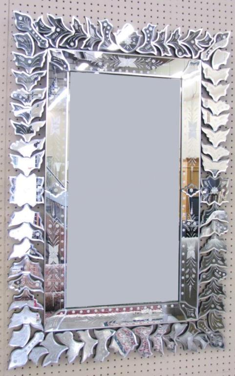 Appraisal: A decorator wall mirror with leaf vine motif mirrored frame