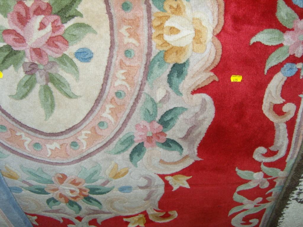 Appraisal: A red ground Chinese wool carpet with floral decoration together