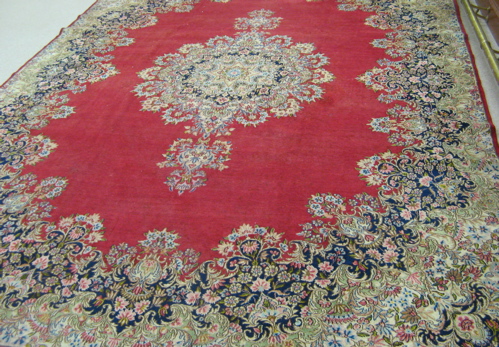 Appraisal: SEMI-ANTIQUE PERSIAN KERMAN CARPET centering a large floral medallion on