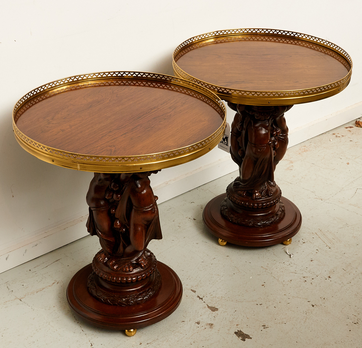 Appraisal: PAIR ITALIAN CARVED WALNUT PUTTO SIDE TABLES th c circular