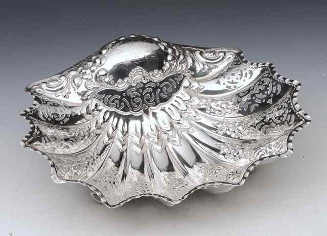 Appraisal: AN EDWARDIAN SILVER SCALLOP SHELL shaped with pressed and pierced