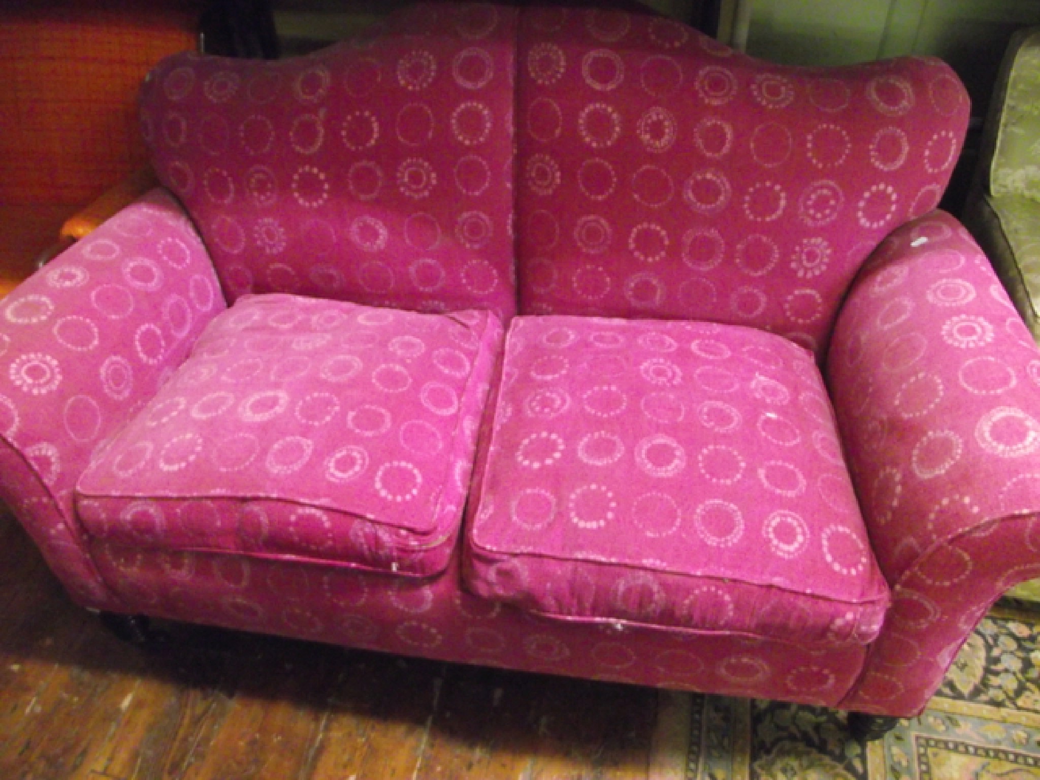 Appraisal: A Victorian upholstered sofa with shaped back and scrolled arms